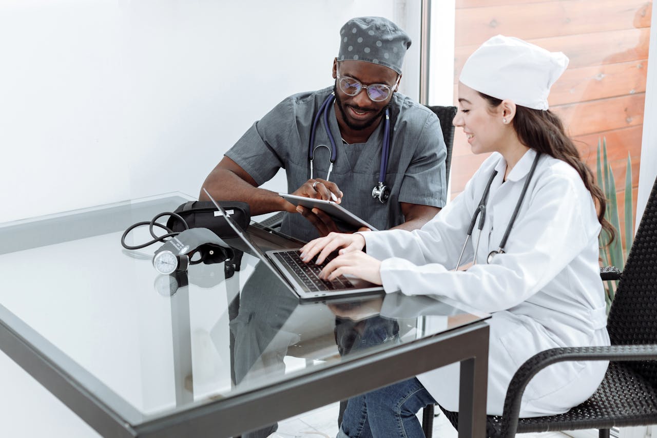 Home Medical professionals collaborating with digital devices in a clinical setting.