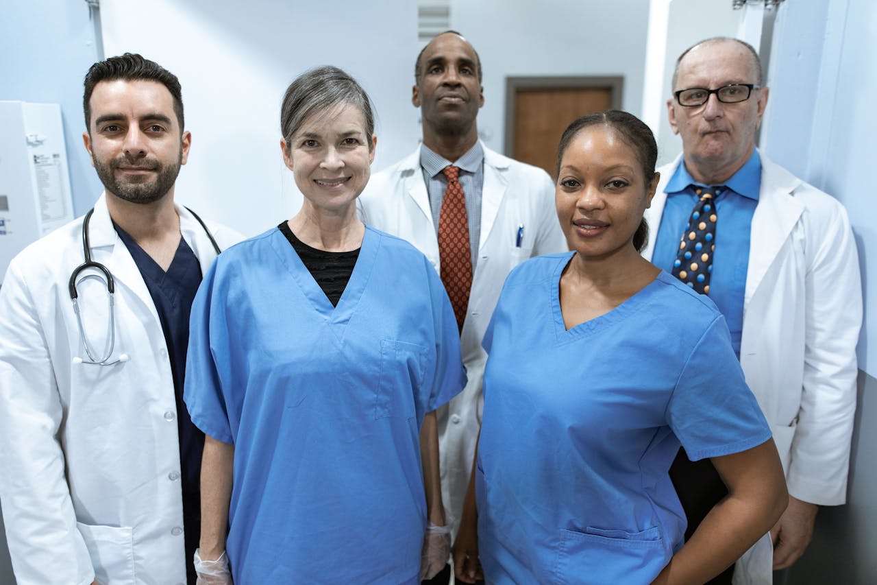 Home Group of diverse healthcare professionals posing confidently indoors.