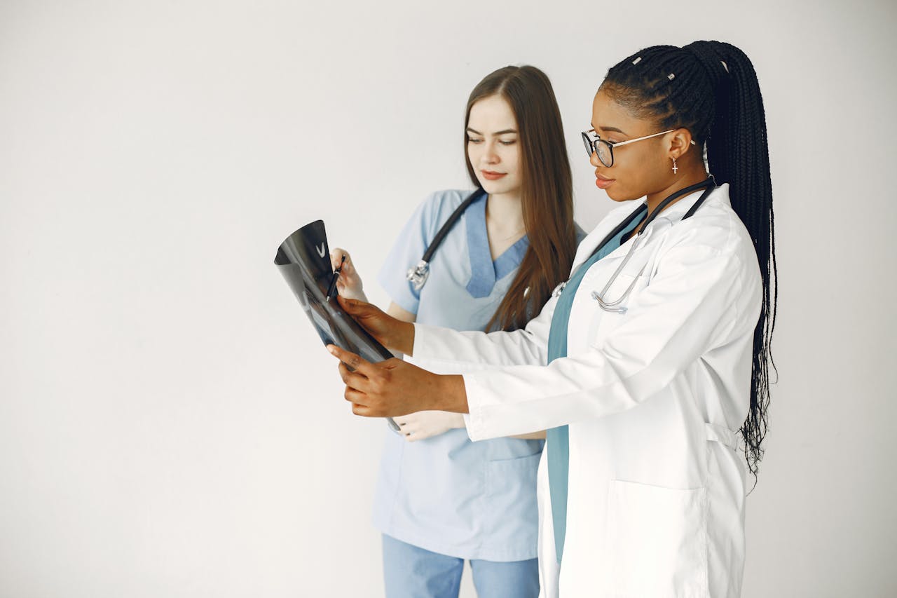 services-02 Two healthcare professionals review x-ray results in a clinical setting.